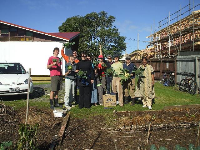 Some members of the Community Garden proudly displaying beautiful organic produce.